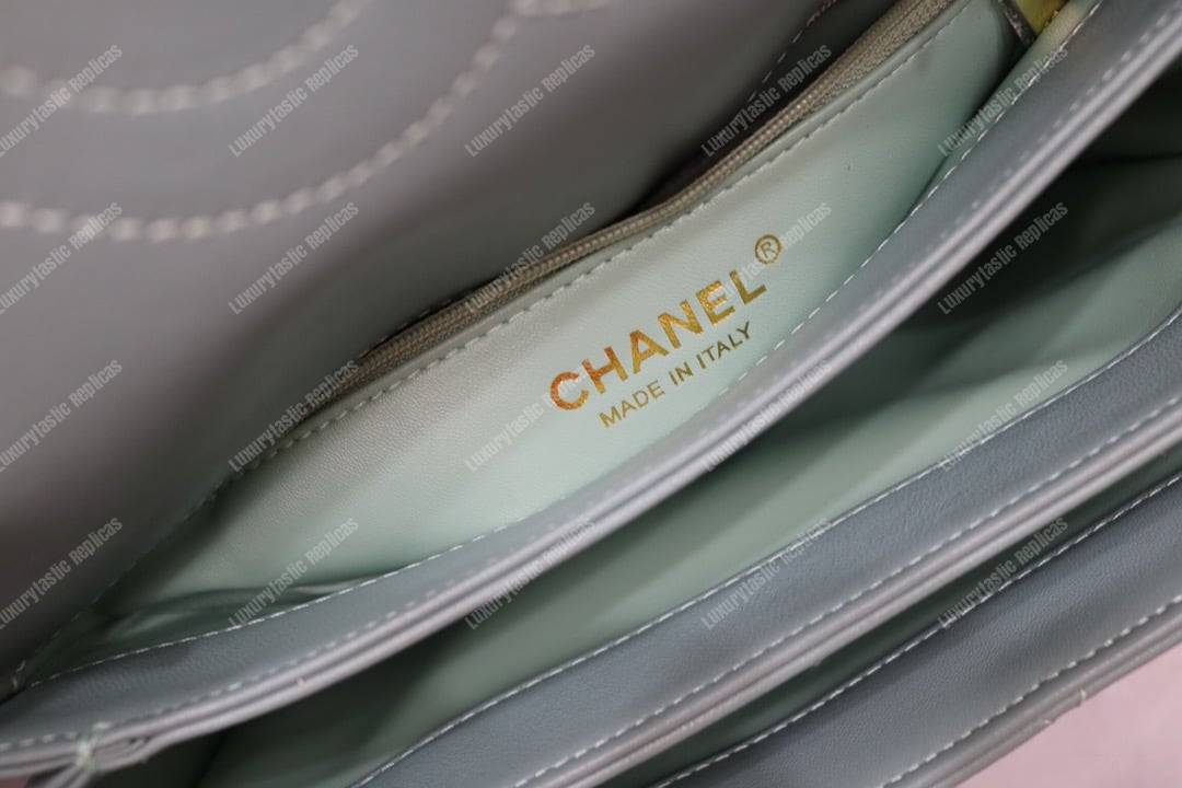Ch*el small flap bag with top handle light blue-gold