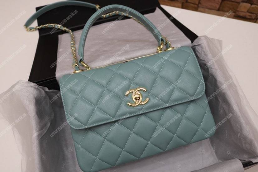 Ch*el small flap bag with top handle light blue-gold