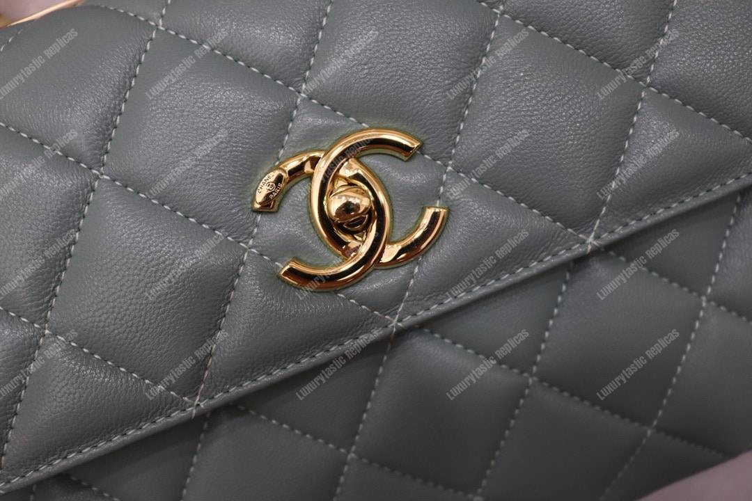 Ch*el small flap bag with top handle light blue-gold
